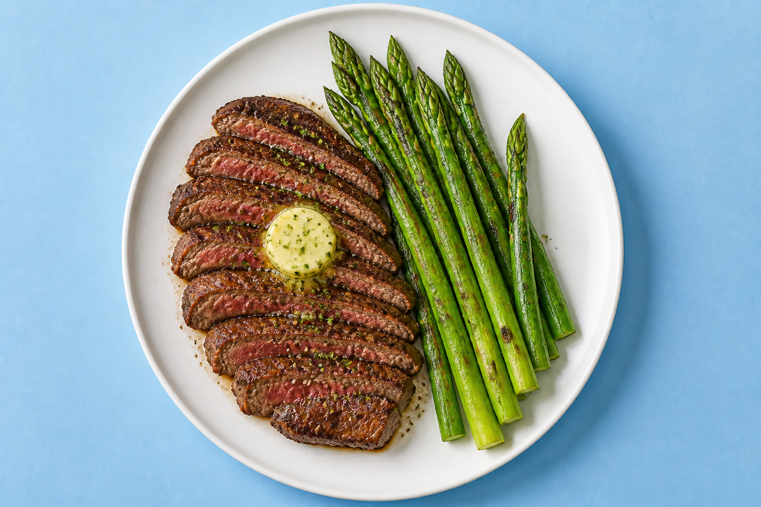 Plate with steak, asparagus, and butter